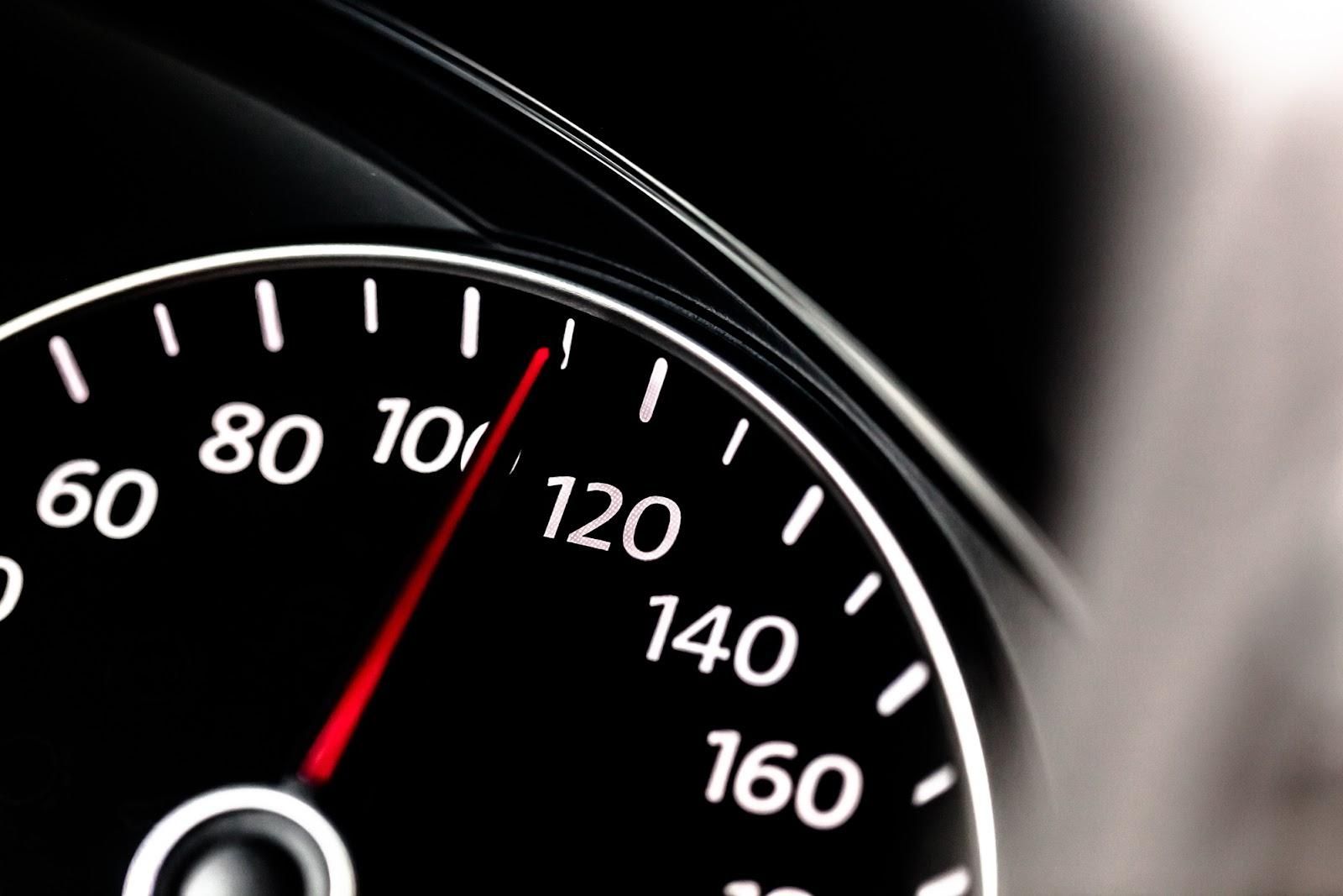 Closeup of speedometer pointing to 110 mph