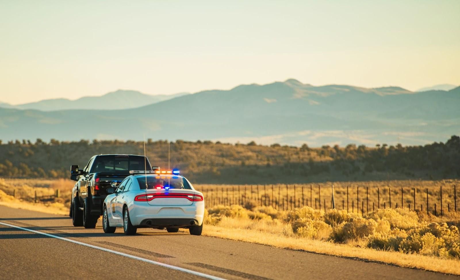 Highway DUI stop in rural area with pickup truck.