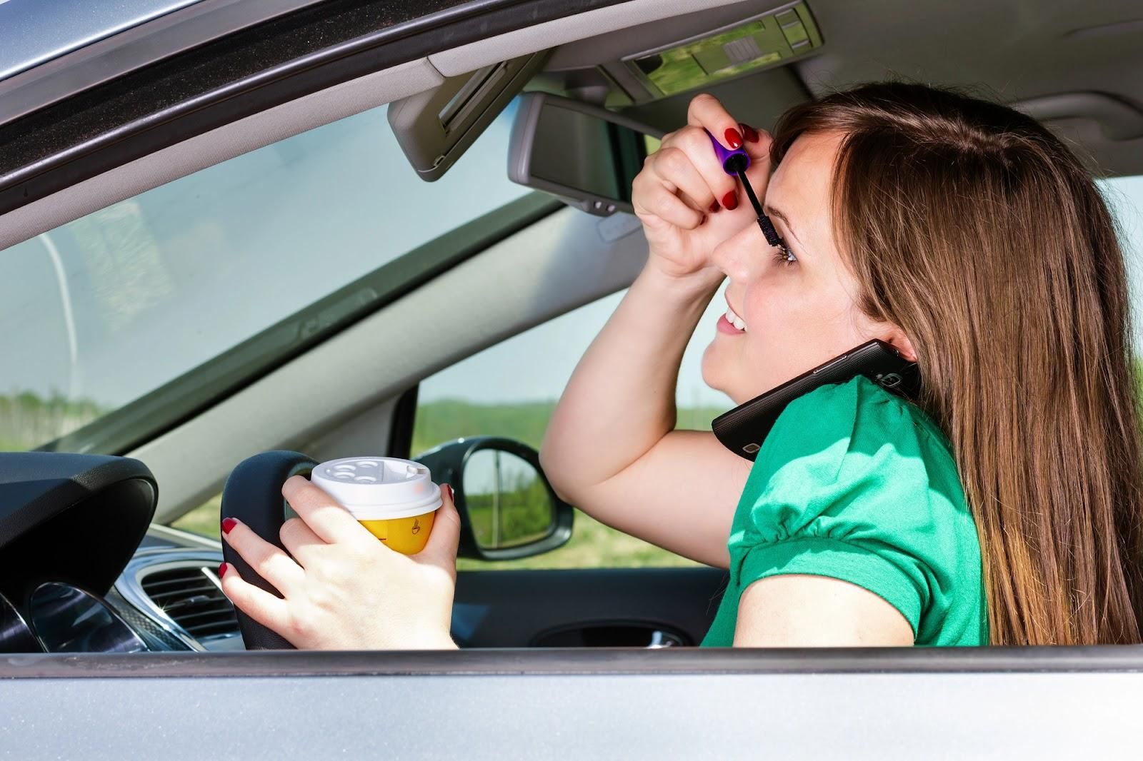 A young woman drives a car while drinking coffee, applying makeup, and talking on her cell phone. Preventing distracted driving starts with changing habits like these.