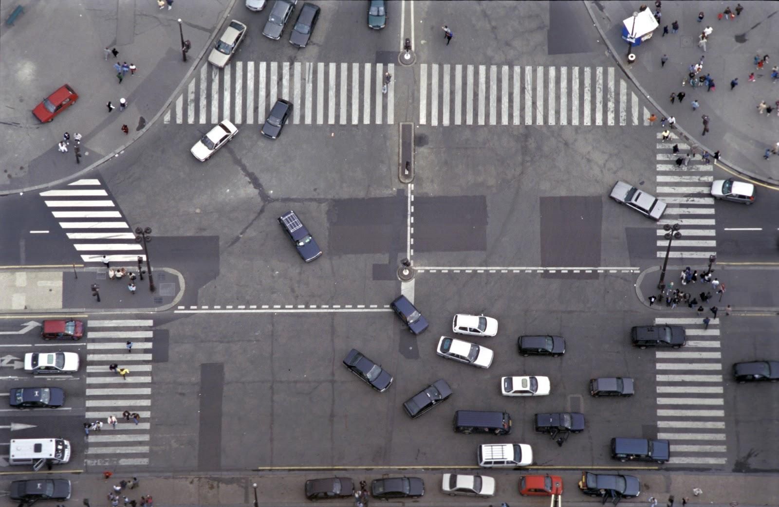 A busy intersection clogged with traffic where drivers must yield according to right-of-way laws.